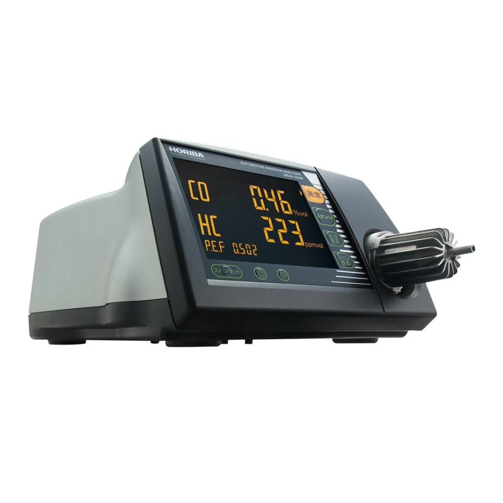Official HORIBA manufacturer photograph for MEXA-324M automotive exhaust gas analyzer, embedded in the brochure cover; retained in full inside a square without cropping